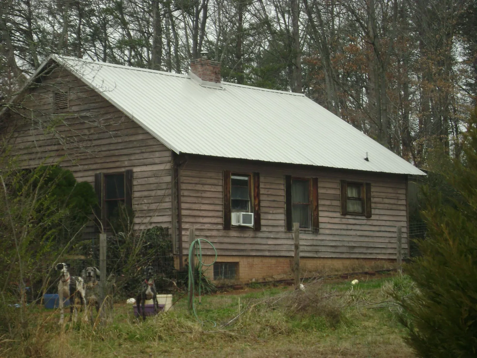 White metal roof on an old wood sided farmhouse, from a Metal Roof Installation job in Greenwood